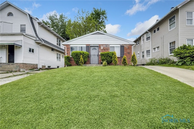 2146 Alvin St, Toledo, OH 43607 - view of front of property featuring brick siding and a front lawn