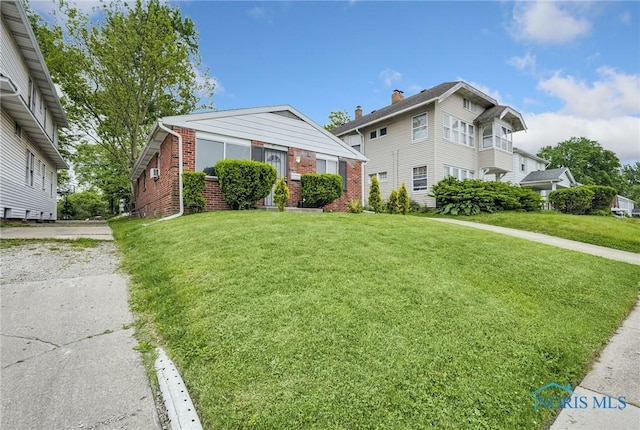 2146 Alvin St, Toledo, OH 43607 - bungalow-style house with brick siding and a front lawn