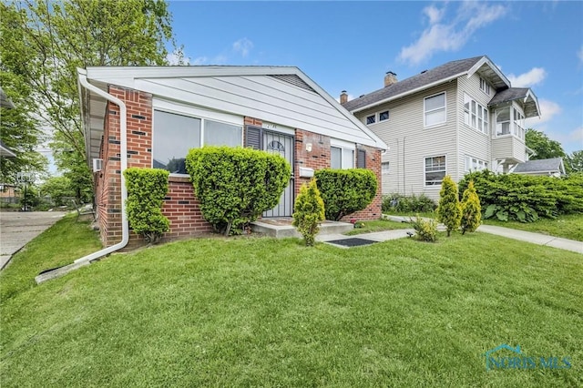 2146 Alvin St, Toledo, OH 43607 - bungalow-style house featuring a front yard and brick siding