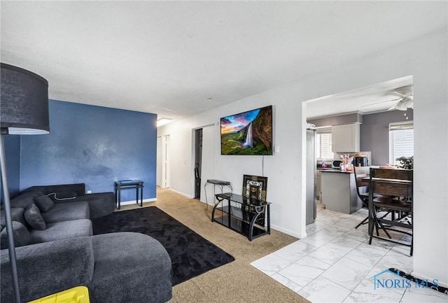 2146 Alvin St, Toledo, OH 43607 - living area featuring ceiling fan, baseboards, and light marble finish flooring