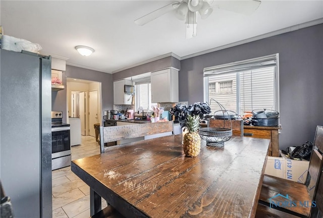 2146 Alvin St, Toledo, OH 43607 - dining area featuring crown molding, ceiling fan, and light marble finish floors