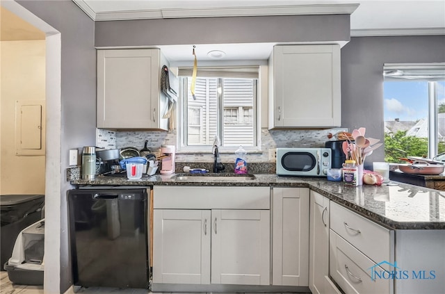 2146 Alvin St, Toledo, OH 43607 - kitchen featuring black dishwasher, a sink, stainless steel microwave, tasteful backsplash, and electric panel