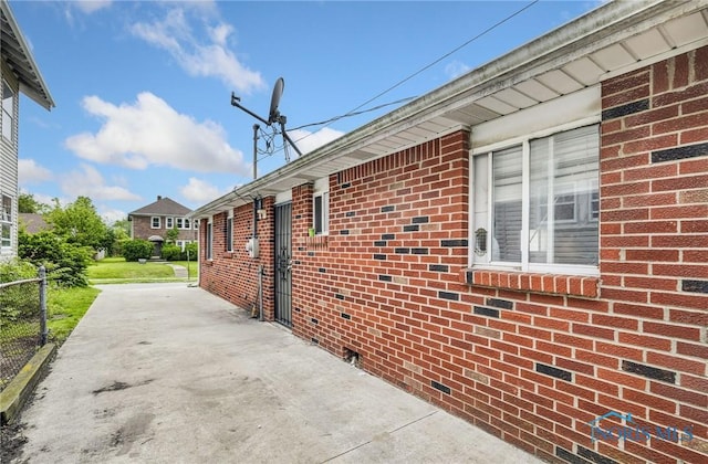 2146 Alvin St, Toledo, OH 43607 - view of side of home with a patio area and brick siding