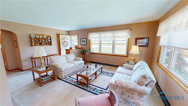 1501 Tiffin Rd, Fremont, OH 43420 - carpeted living area featuring plenty of natural light, arched walkways, and baseboards