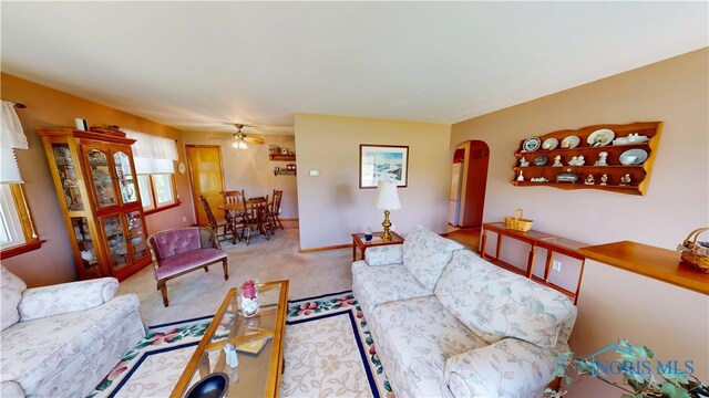 1501 Tiffin Rd, Fremont, OH 43420 - carpeted living area featuring arched walkways and a ceiling fan