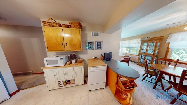 1501 Tiffin Rd, Fremont, OH 43420 - kitchen with white appliances, light countertops, a ceiling fan, a peninsula, and baseboards