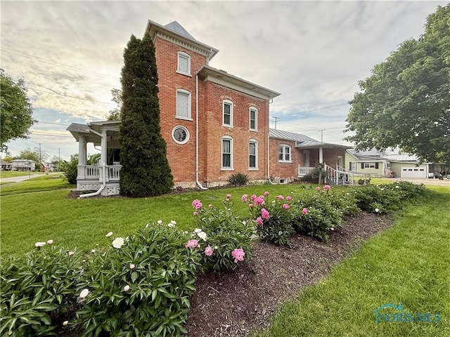 206 W Main St, Fayette, OH 43521 - view of side of home featuring a lawn and brick siding