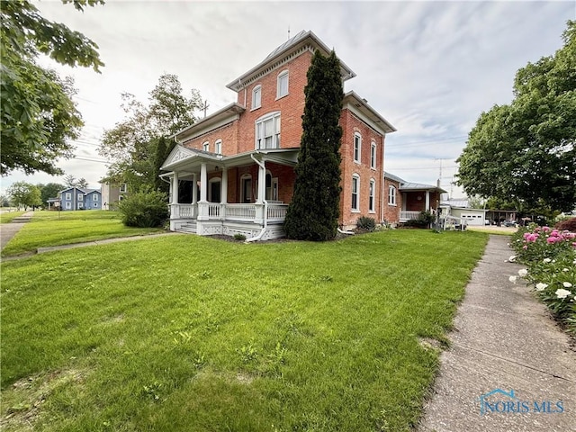 206 W Main St, Fayette, OH 43521 - view of front facade with a porch, brick siding, and a front lawn