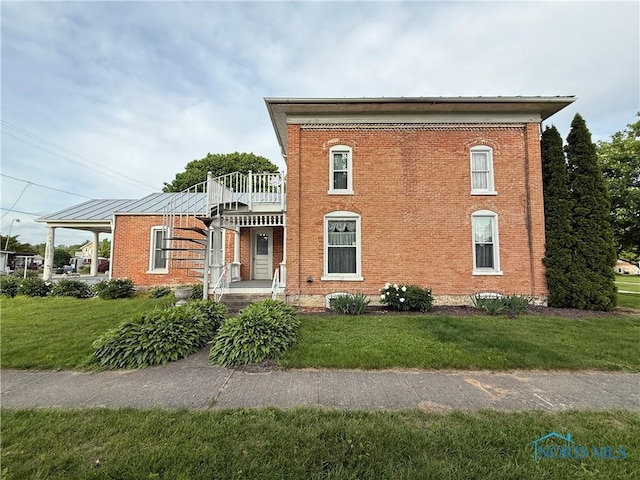 206 W Main St, Fayette, OH 43521 - italianate home featuring brick siding, a front lawn, and a balcony