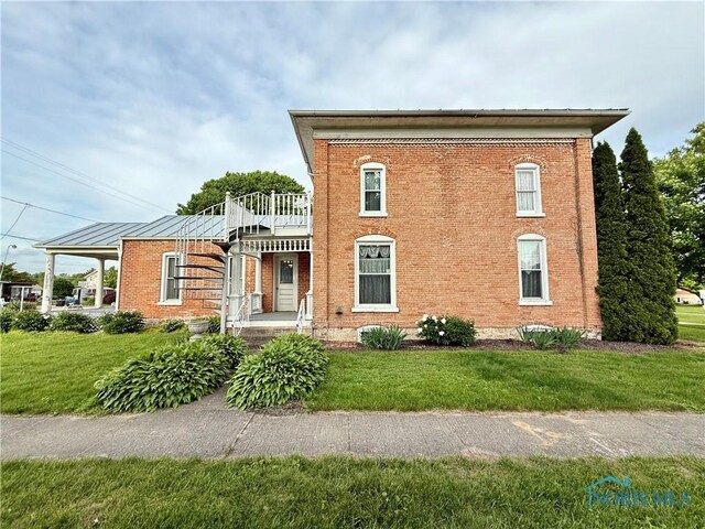 206 W Main St, Fayette, OH 43521 - italianate-style house with brick siding, a front lawn, and a balcony