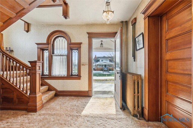 206 W Main St, Fayette, OH 43521 - foyer featuring carpet floors, stairway, and a chandelier