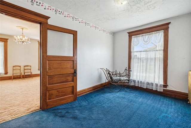 206 W Main St, Fayette, OH 43521 - unfurnished room with dark carpet, a chandelier, baseboards, and a textured ceiling