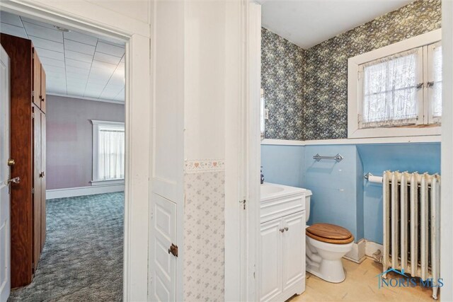 206 W Main St, Fayette, OH 43521 - half bath with radiator, wallpapered walls, toilet, vanity, and wainscoting