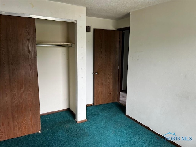 3431 Worley Pl, Toledo, OH 43608 - unfurnished bedroom with carpet, a closet, a textured ceiling, and baseboards