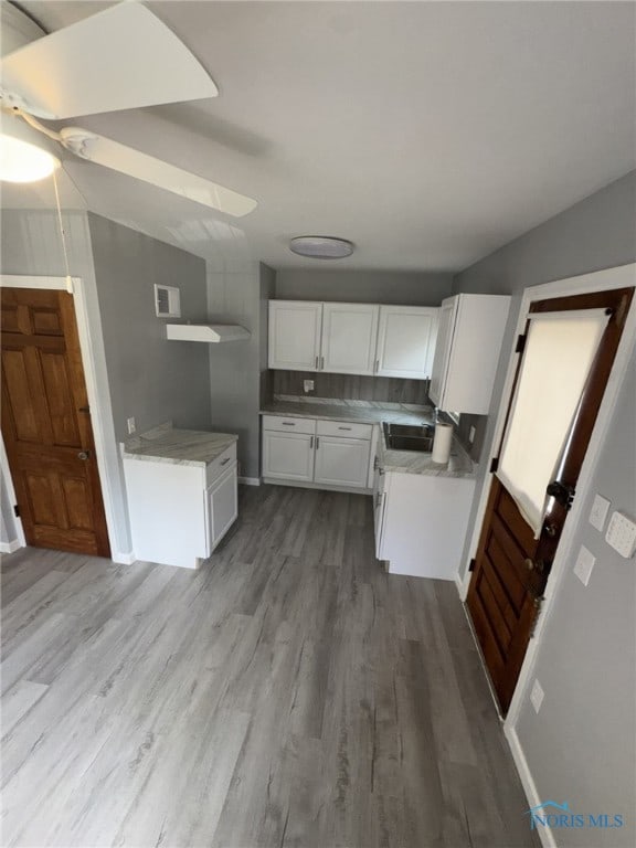 642 Brookley Blvd, Toledo, OH 43607 - kitchen with wood finished floors, white cabinetry, light countertops, ceiling fan, and a sink