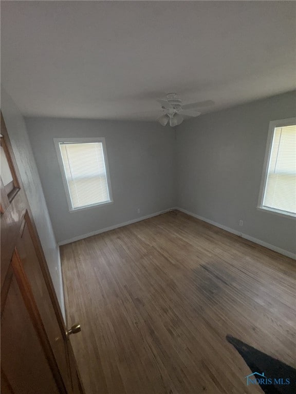 642 Brookley Blvd, Toledo, OH 43607 - empty room with wood finished floors, a ceiling fan, and baseboards