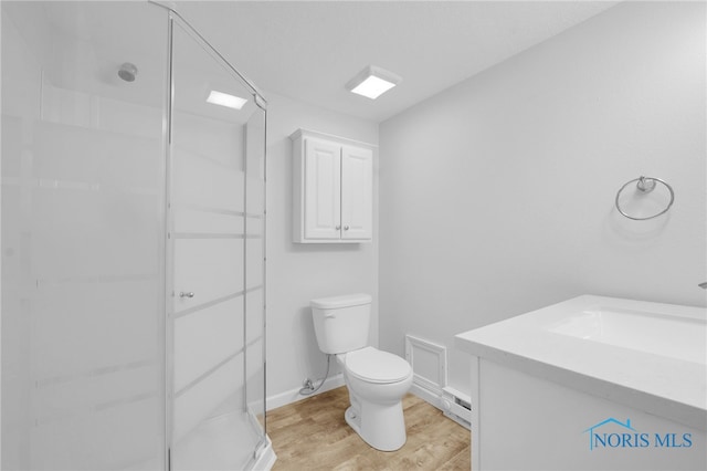 4238 Knollcrest Rd, Toledo, OH 43611 - full bathroom featuring baseboard heating, toilet, vanity, a shower stall, and wood finished floors