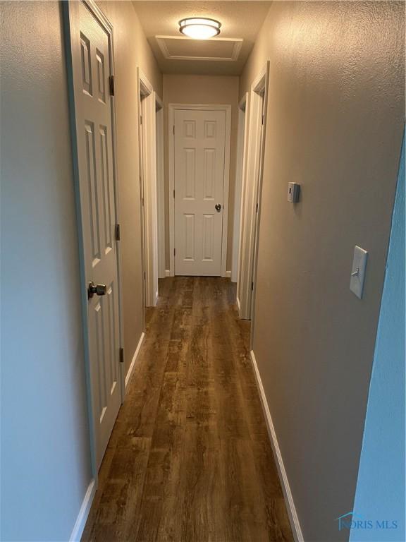 210 W William St, Maumee, OH 43537 - hall with attic access, dark wood finished floors, and baseboards