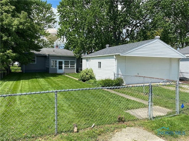 210 W William St, Maumee, OH 43537 - rear view of house with a garage and a shingled roof