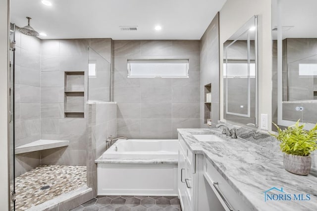2714 W Rockridge Cir, Toledo, OH 43606 - full bath featuring a garden tub, tiled shower, vanity, tile patterned floors, and recessed lighting