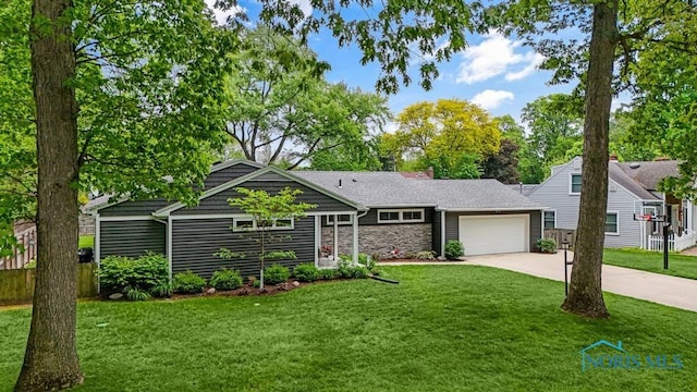 2714 W Rockridge Cir, Toledo, OH 43606 - view of front of property with driveway, stone siding, an attached garage, and a front lawn
