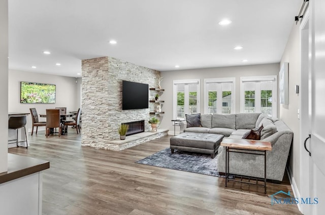 2714 W Rockridge Cir, Toledo, OH 43606 - living area with recessed lighting, wood finished floors, a fireplace, and baseboards