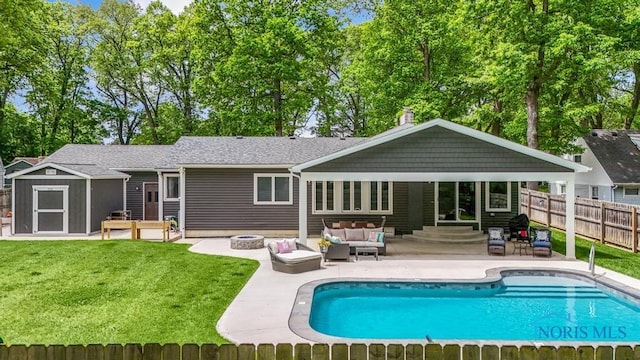 2714 W Rockridge Cir, Toledo, OH 43606 - back of property featuring an outdoor living space with a fire pit, a patio area, a chimney, entry steps, and an outdoor structure