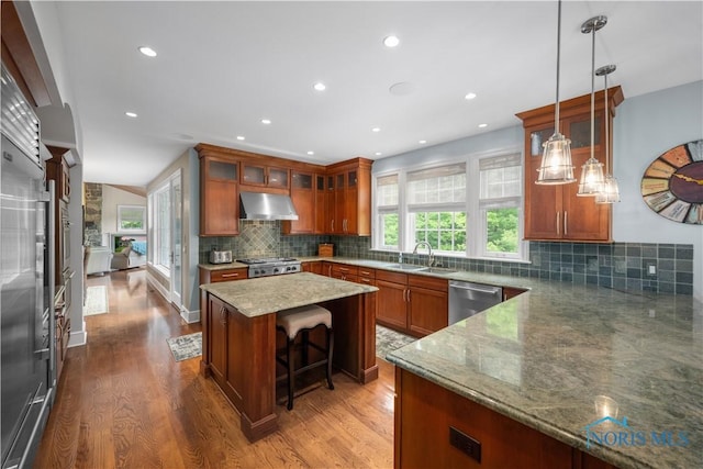 1860 Watermill Ln, Perrysburg, OH 43551 - kitchen with extractor fan, appliances with stainless steel finishes, a sink, brown cabinetry, and wood finished floors