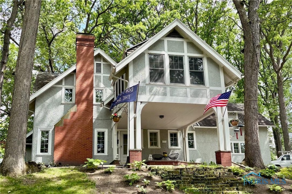 431 Forest Dr, Rossford, OH 43460 - rear view of house featuring stucco siding and a chimney
