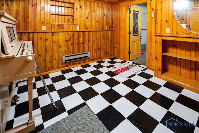 555 Race St, Clyde, OH 43410 - spare room with baseboard heating, wood walls, and tile patterned floors