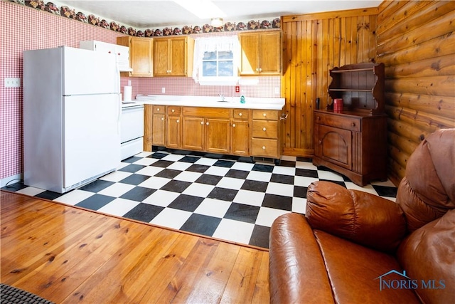 555 Race St, Clyde, OH 43410 - kitchen with white appliances, light countertops, dark floors, brown cabinets, and a sink