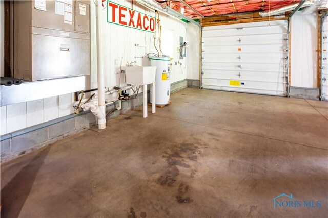 555 Race St, Clyde, OH 43410 - garage with water heater and a sink