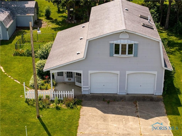 555 Race St, Clyde, OH 43410 - view of front of property featuring a shingled roof, a garage, and concrete driveway