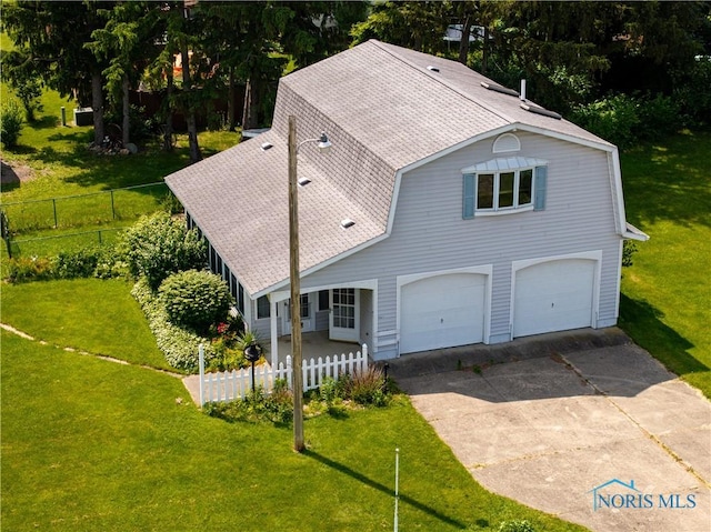 555 Race St, Clyde, OH 43410 - view of front facade featuring driveway, a garage, and roof with shingles