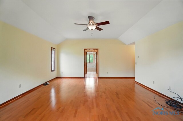 4820 Olde Meadow Ln, Sylvania, OH 43560 - spare room with a ceiling fan, baseboards, lofted ceiling, and light wood-type flooring