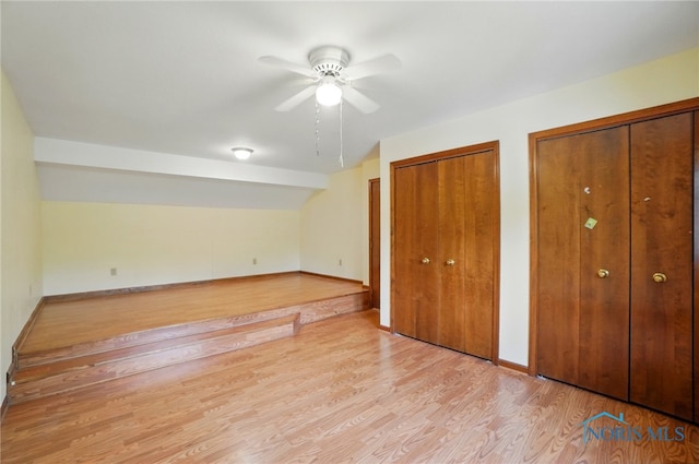 4820 Olde Meadow Ln, Sylvania, OH 43560 - unfurnished bedroom with multiple closets, light wood-type flooring, a ceiling fan, and baseboards