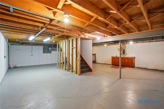 4820 Olde Meadow Ln, Sylvania, OH 43560 - unfinished basement with stairs, brick wall, and electric panel