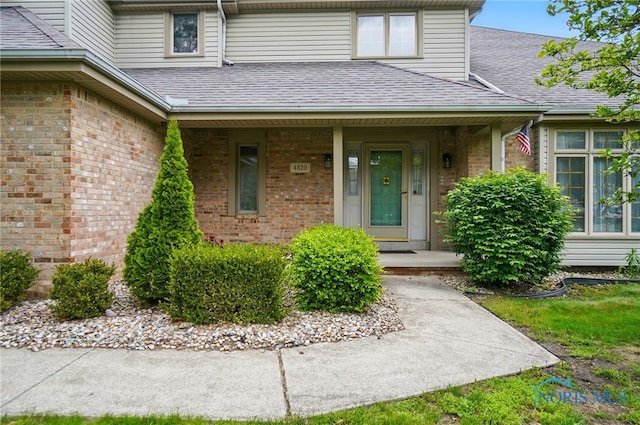 4820 Olde Meadow Ln, Sylvania, OH 43560 - entrance to property with a shingled roof, brick siding, and a porch