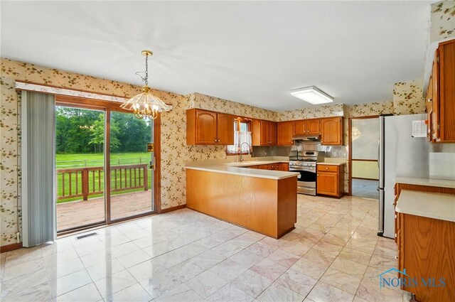 4820 Olde Meadow Ln, Sylvania, OH 43560 - kitchen with stainless steel appliances, wallpapered walls, a sink, a peninsula, and light countertops