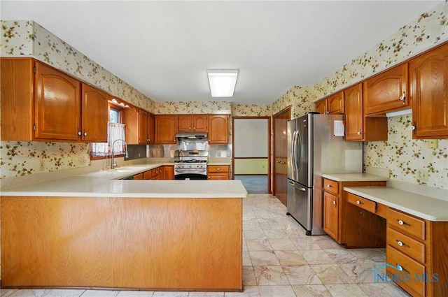 4820 Olde Meadow Ln, Sylvania, OH 43560 - kitchen featuring stainless steel appliances, wallpapered walls, under cabinet range hood, a sink, and light countertops