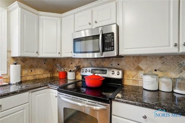 8420 Willow Glen Ct, Holland, OH 43528 - kitchen with appliances with stainless steel finishes, white cabinetry, decorative backsplash, and dark stone counters