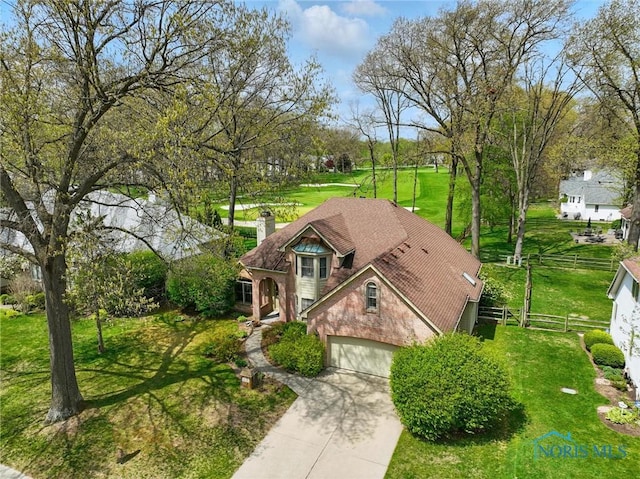 8420 Willow Glen Ct, Holland, OH 43528 - view of front of house with concrete driveway, a chimney, stucco siding, and an attached garage