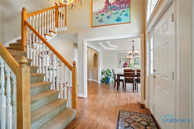 8420 Willow Glen Ct, Holland, OH 43528 - foyer entrance featuring a chandelier, hardwood / wood-style flooring, baseboards, stairway, and healthy amount of natural light