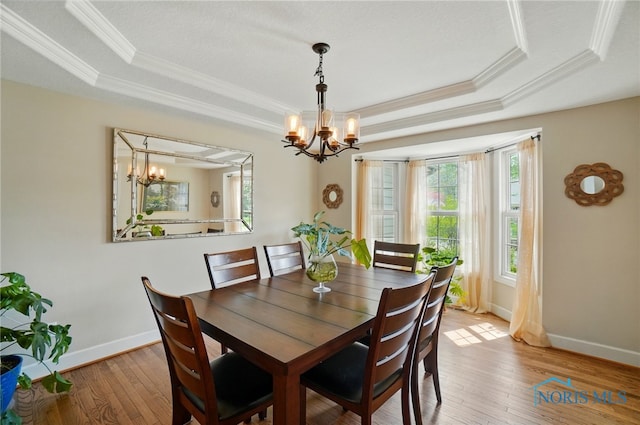 8420 Willow Glen Ct, Holland, OH 43528 - dining area with a tray ceiling, a chandelier, plenty of natural light, and ornamental molding