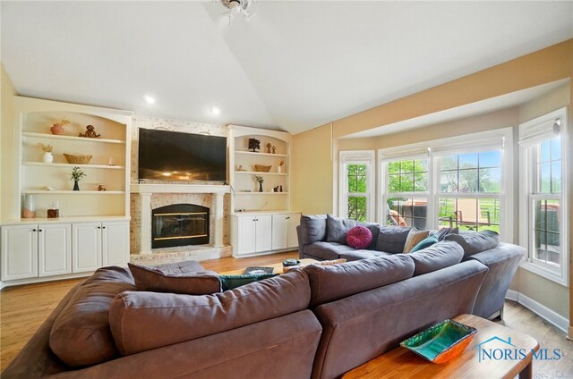 8420 Willow Glen Ct, Holland, OH 43528 - living room featuring light wood-type flooring, lofted ceiling, a large fireplace, and recessed lighting