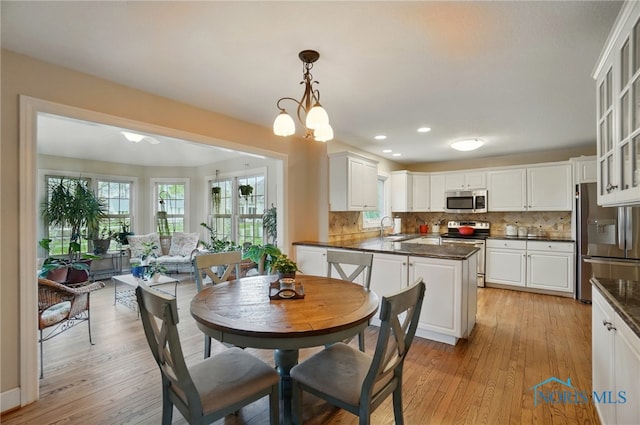 8420 Willow Glen Ct, Holland, OH 43528 - dining space featuring healthy amount of natural light, light wood-type flooring, and recessed lighting