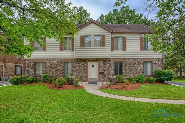 1711 Brownstone Blvd, Toledo, OH 43614 - view of property featuring a front lawn, central AC, and brick siding