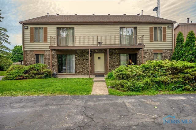 1711 Brownstone Blvd, Toledo, OH 43614 - multi unit property with a front lawn, a balcony, and brick siding