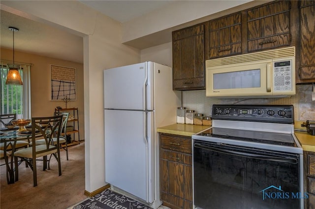 1711 Brownstone Blvd, Toledo, OH 43614 - kitchen featuring white appliances, dark brown cabinetry, carpet flooring, light countertops, and decorative backsplash