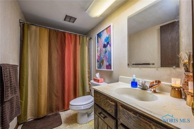 1711 Brownstone Blvd, Toledo, OH 43614 - bathroom featuring toilet, vanity, and curtained shower